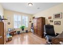 Well-lit home office with hardwood floors, shuttered windows, and plenty of storage at 175 Basket Grass Ln, Summerville, SC 29486