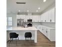 Bright kitchen featuring stainless steel appliances, white cabinets and quartz countertop on kitchen island at 1906 Gumwood Blvd, North Charleston, SC 29406