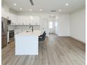Open kitchen and living area with stainless steel appliances and large island with bar stool seating at 1906 Gumwood Blvd, North Charleston, SC 29406
