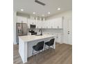 Modern kitchen with stainless steel appliances, white cabinets and an island with bar stool seating at 1906 Gumwood Blvd, North Charleston, SC 29406