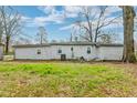Large grassy backyard with mature trees offers a peaceful outdoor setting at 20 Stratton Dr, Charleston, SC 29420