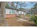 Charming single-story home with fenced yard and walkway to the front door and porch at 20 Stratton Dr, Charleston, SC 29420