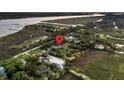 Aerial view showcases the property's location nestled among lush greenery near the water at 200 Wappoo Rd, Charleston, SC 29407