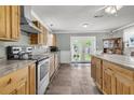 Well-lit kitchen featuring stainless steel appliances, wood cabinets, and island with stone countertops at 200 Wappoo Rd, Charleston, SC 29407