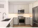 Updated kitchen showcasing stainless steel appliances, granite countertops, and stylish cabinetry at 21 George St # 206, Charleston, SC 29401