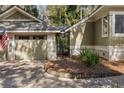Attached two-car garage with neutral doors and nice landscaping and an iron gate at 2105 Loblolly Ln, Seabrook Island, SC 29455
