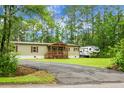 Charming single-story home with a inviting front porch and lush greenery at 222 Sinclair Rd, Summerville, SC 29483