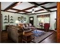 Cozy living room with wood-beamed ceiling, comfortable seating, and a large window at 222 Sinclair Rd, Summerville, SC 29483