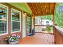 Inviting front porch with wooden accents, cozy seating, and decorative touches at 222 Sinclair Rd, Summerville, SC 29483