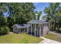 A classic brick home featuring a welcoming porch with prominent white pillars at 2340 Ashley River Rd, Charleston, SC 29414