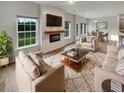 Bright living room featuring a fireplace, modern furniture and backyard view at 242 Daniels Creek Cir, Goose Creek, SC 29445