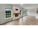 Bright, open-concept living room with fireplace and access to outdoor patio at 242 Daniels Creek Cir, Goose Creek, SC 29445