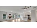 Open-concept living space with fireplace, kitchen and stainless steel appliances at 242 Daniels Creek Cir, Goose Creek, SC 29445