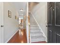 Home entryway with hardwood floors and stairway leading to the upper level at 2488 Stadium Dr, North Charleston, SC 29406