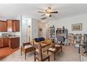 Cozy living room with plush carpet, ceiling fan, and natural light with a kitchenette area at 2488 Stadium Dr, North Charleston, SC 29406