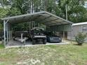 Metal carport with a boat on a trailer, a UTV and a car stored inside at 277 Carolina Cir, Walterboro, SC 29488