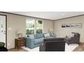 Bright living room featuring comfortable blue sofa and stylish decor, creating a cozy atmosphere at 282 Marion Rd, Dorchester, SC 29437
