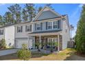 Inviting two-story home with a covered porch, brick accents, and a neatly maintained lawn at 301 Dunlin Dr, Summerville, SC 29486