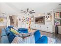 Stylish living room featuring custom built-ins, a ceiling fan, and a comfortable blue sectional sofa at 301 Dunlin Dr, Summerville, SC 29486