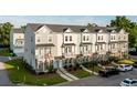 Angled exteriors of townhomes featuring balconies, neutral colors, and professional landscaping at 304 Pathfinder Way, Charleston, SC 29492