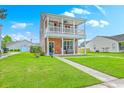 Inviting two-story home with a neat lawn and a cozy front porch with comfortable seating at 309 Harriswood Ln, Moncks Corner, SC 29461