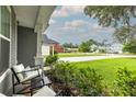 Inviting front porch seating area with views of a lush, green neighborhood at 3257 Timberline Dr, Johns Island, SC 29455