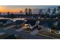 Aerial view of homes near the lake with dark rooftops and beautiful sky during sunset at 357 Tupelo Lake Dr, Summerville, SC 29486