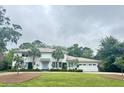 Beautiful two-story home with a three-car garage, a well-manicured lawn, and mature landscaping at 37 Fort Royal Ave, Charleston, SC 29407