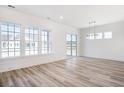 Bright living room features light wood floors, multiple windows and natural light, and white walls at 432 Evening Glow Ln, Summerville, SC 29486