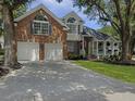 Traditional home with a two-car garage, well-kept lawn, and inviting front porch at 482 Planters Trace Dr, Charleston, SC 29412