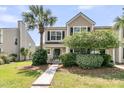 Charming two-story home with a well-manicured lawn and a beautiful palm tree in daytime at 4823 Shady Tree Ln, Summerville, SC 29485