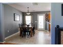 Dining room with a wooden table, seating for six, neutral paint, and view into the kitchen at 5094 Thornton Dr, Summerville, SC 29485