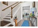 Inviting entryway with hardwood floors, staircase and views to the living and kitchen area at 512 Alderly Dr, Moncks Corner, SC 29461