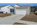 Attractive home with neutral siding, a two-car garage, and a pleasant front porch area with seating at 576 Polaris Way, Summerville, SC 29486