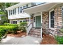 Welcoming front porch with brick steps, a painted green door, and beautiful brick facade at 886 Friendly Cir, Charleston, SC 29414
