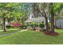 Attractive two-story home with a lush green lawn, mature trees, and a welcoming front entrance at 8967 N Red Maple Cir, Summerville, SC 29485