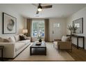 Cozy living room features a neutral color palette, large window, and stylish furnishings at 103 Four Iron Dr, Summerville, SC 29483