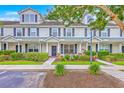 Attractive townhome showcasing a well-maintained lawn, inviting entrance, and classic design elements at 108 Hemingway Cir, Summerville, SC 29483