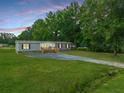 Charming home with a lush green lawn and a welcoming front porch, set against a beautiful sunset sky at 108 Swanson Dr, Summerville, SC 29483
