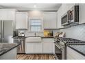 Contemporary kitchen featuring white cabinets, stainless steel appliances, and tile backsplash at 116 Crosscut Ln, Summerville, SC 29486