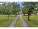 Gravel driveway leading to a home and partially obscured by trees at 117 Ponderosa Rd, Summerville, SC 29483