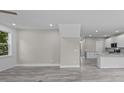 Open-concept living room featuring light gray wood flooring, recessed lighting and modern finishes at 125 Ridge Rd, Summerville, SC 29485