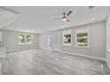 Spacious living room with new flooring, abundant natural light, and a ceiling fan at 125 Ridge Rd, Summerville, SC 29485