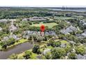 Aerial view of a charming home in a picturesque community with a lake and green spaces at 134 Etiwan Park St, Charleston, SC 29492