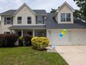 Charming two-story home with a manicured lawn, and a two-car garage at 164 Historic Dr, Mount Pleasant, SC 29464