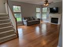 Bright living room featuring hardwood floors, a fireplace, and natural light at 164 Historic Dr, Mount Pleasant, SC 29464