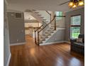 Comfortable living room with staircase and hardwood floors, adjacent to an eat-in kitchen at 164 Historic Dr, Mount Pleasant, SC 29464