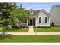 Attractive home featuring a manicured lawn, sidewalk, and inviting front porch for relaxing at 1722 Winfield Way, Charleston, SC 29414