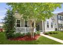 Quaint home with a cozy front porch, lush lawn, and tasteful landscaping at 1722 Winfield Way, Charleston, SC 29414
