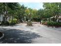 Entrance to the community with black metal gates, surrounded by lush greenery and mature trees at 1755 Central Park Rd # 9103, Charleston, SC 29412